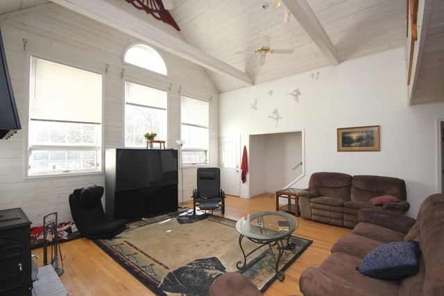 9-n301 Percy Road Maple Park, IL 60151 - Photo 3 of 25 a living room with furniture a large window and a flat screen tv