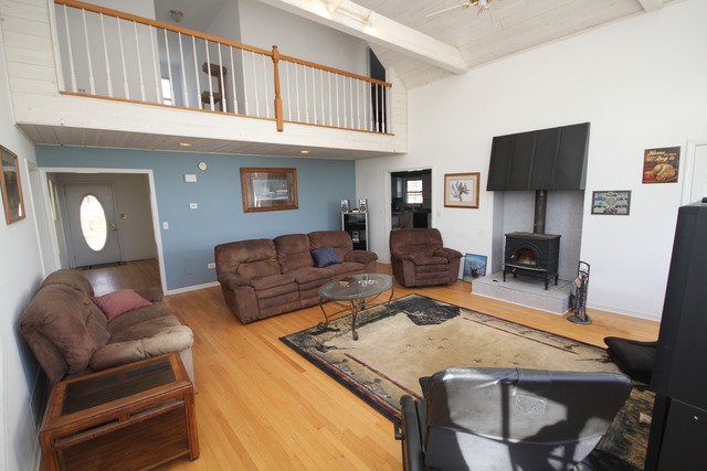 9-n301 Percy Road Maple Park, IL 60151 - Photo 5 of 25 a living room with furniture a flat screen tv and kitchen view