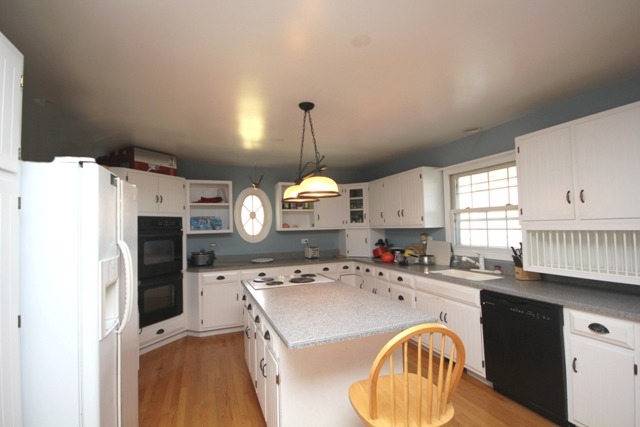 9-n301 Percy Road Maple Park, IL 60151 - Photo 8 of 25 a kitchen with a refrigerator a sink a stove and cabinets