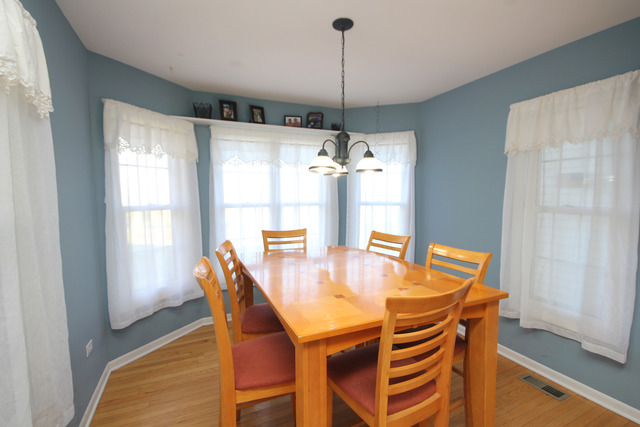 9-n301 Percy Road Maple Park, IL 60151 - Photo 10 of 25 a dining room with furniture a chandelier and wooden floor