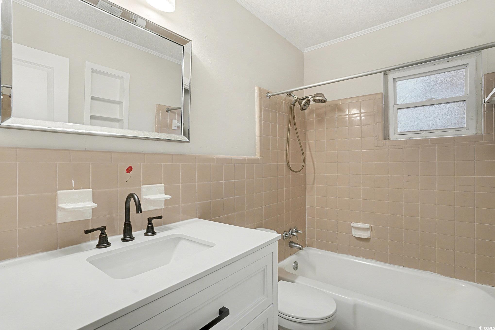 603 Maple Street Myrtle Beach, SC 29577 - Photo 16 of 40 Full bath with shower / bath combination, vanity, tile walls, and ornamental molding