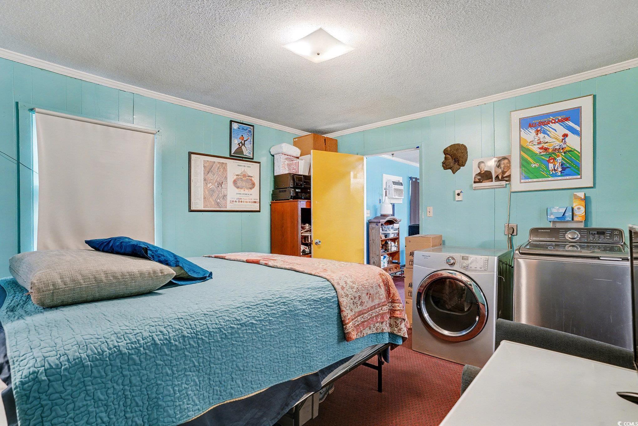 603 Maple Street Myrtle Beach, SC 29577 - Photo 22 of 40 Bedroom featuring ornamental molding, a textured ceiling, and washing machine and dryer