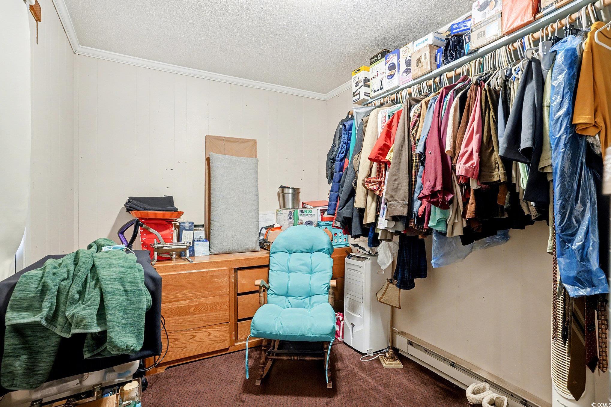 603 Maple Street Myrtle Beach, SC 29577 - Photo 25 of 40 Spacious closet featuring a baseboard radiator and dark carpet