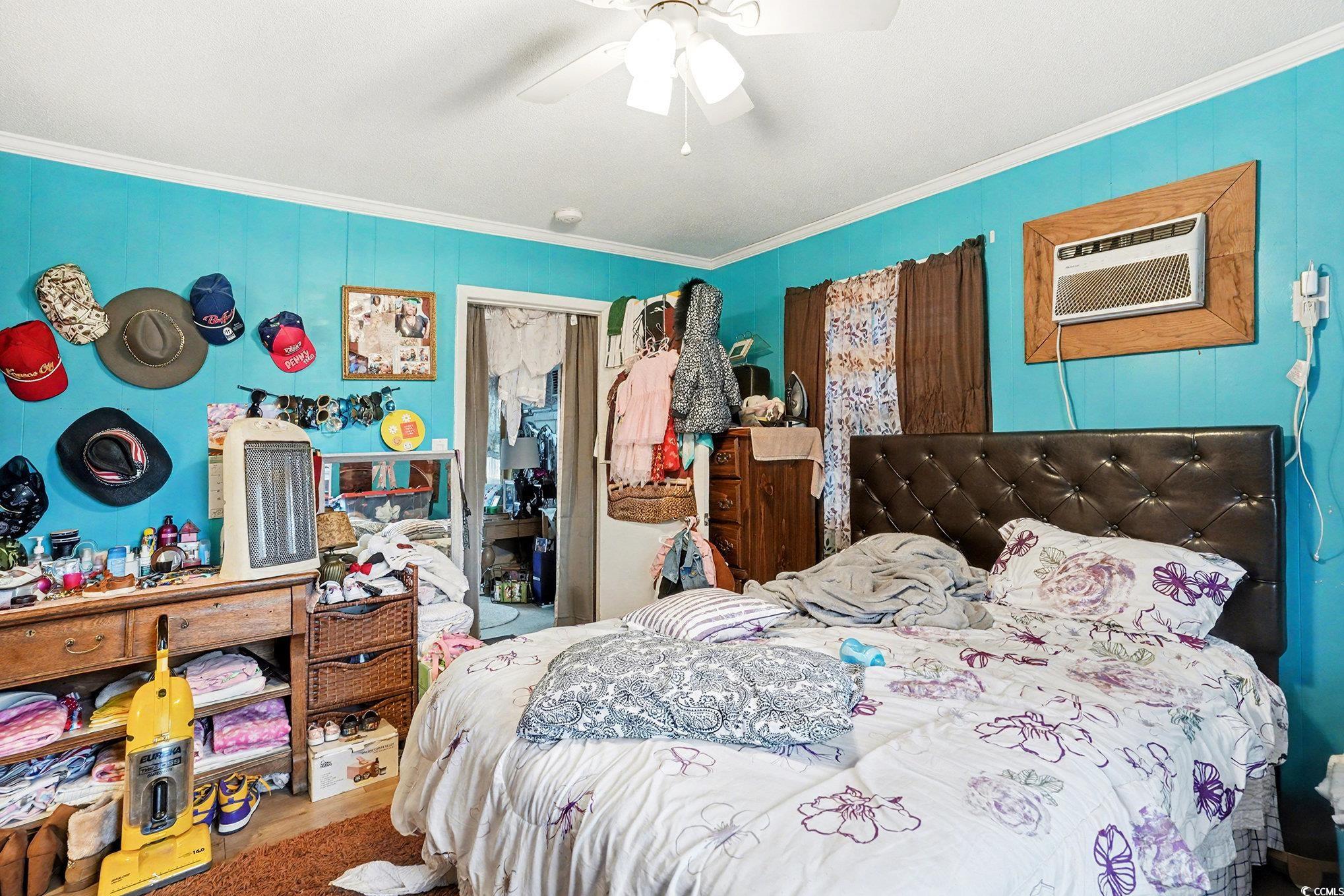 603 Maple Street Myrtle Beach, SC 29577 - Photo 32 of 40 Bedroom featuring ornamental molding, ceiling fan, and a wall mounted AC