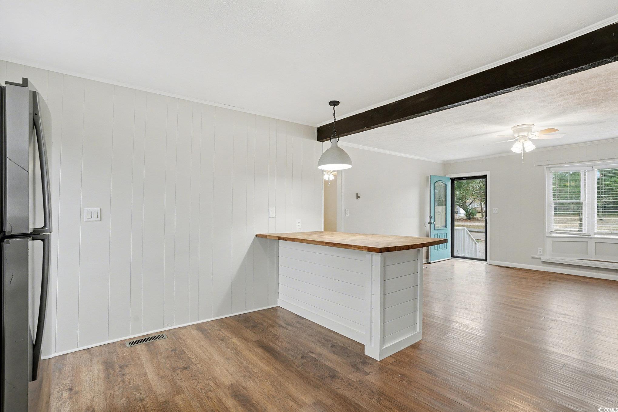 603 Maple Street Myrtle Beach, SC 29577 - Photo 9 of 40 Kitchen with butcher block countertops, dark wood finished floors, freestanding refrigerator, a peninsula, and pendant lighting
