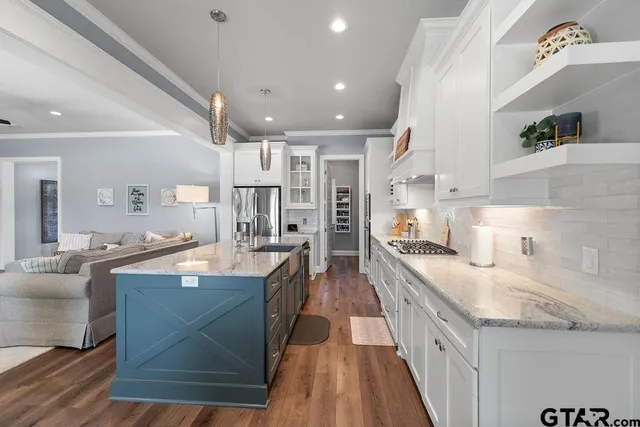 a large kitchen with stainless steel appliances lots of counter space and breakfast area