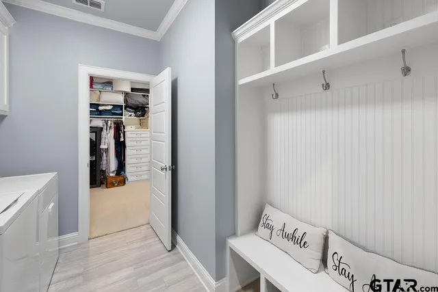 a hallway with cabinets and wooden floor
