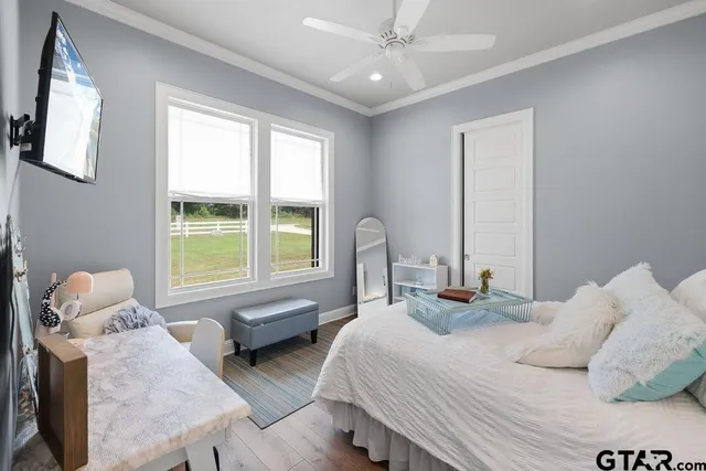 a bedroom with two beds and a large window