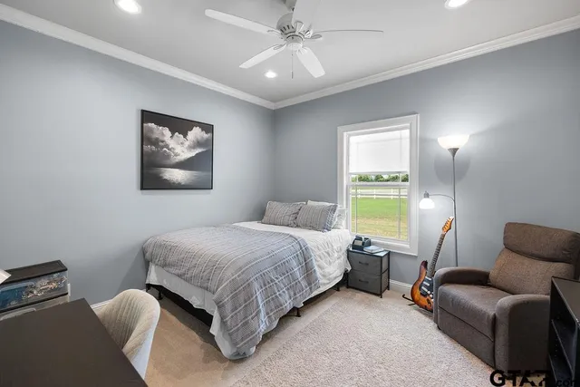 a bedroom with a bed couch and a window