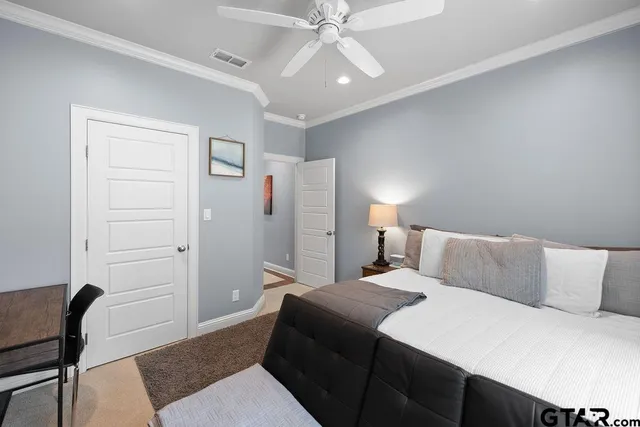 a bedroom with a bed and a chair