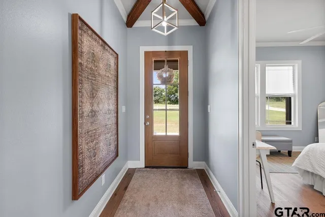 a view of an entryway with wooden floor and a livingroom