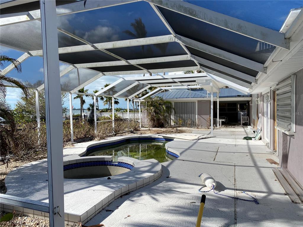 12440 Placida Road Placida, FL 33946 - Photo 3 of 96 a view of a porch with furniture and floor to ceiling window