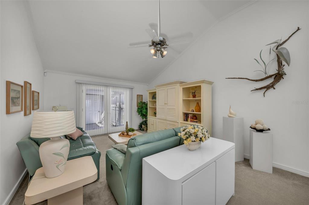 12440 Placida Road Placida, FL 33946 - Photo 36 of 96 a living room with furniture a chandelier and a window