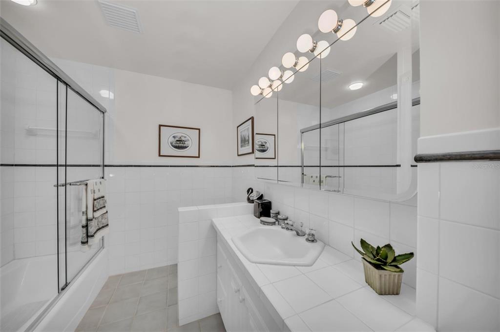 12440 Placida Road Placida, FL 33946 - Photo 47 of 96 a bathroom with a sink a faucet a lamp and a mirror