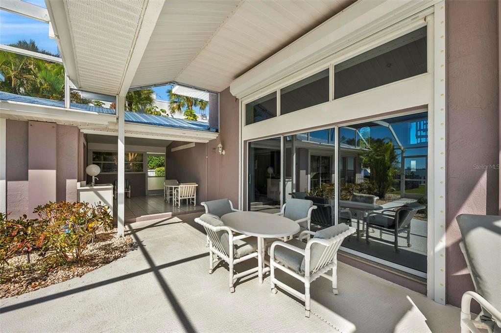 12440 Placida Road Placida, FL 33946 - Photo 62 of 96 a view of a patio with table and chairs and potted plants
