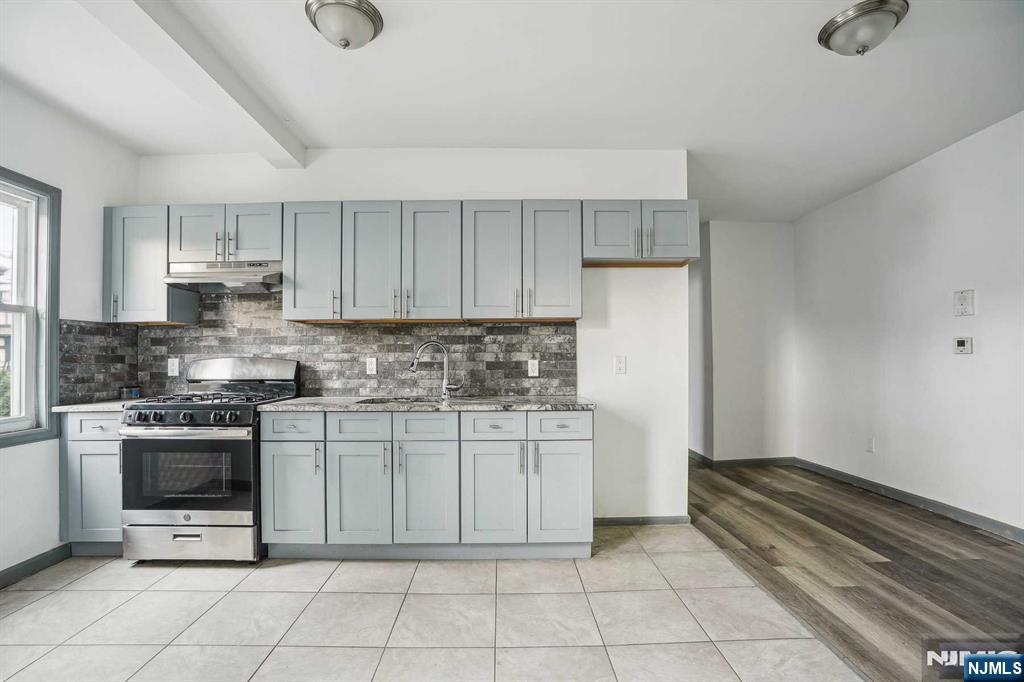 143 Valley Road, Unit 1R Montclair, NJ 07042 - Photo 8 of 18 a kitchen with a stove top oven and cabinets