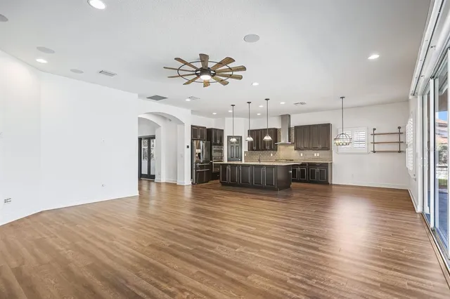 a bathroom with a granite countertop sink a toilet a mirror and bathtub