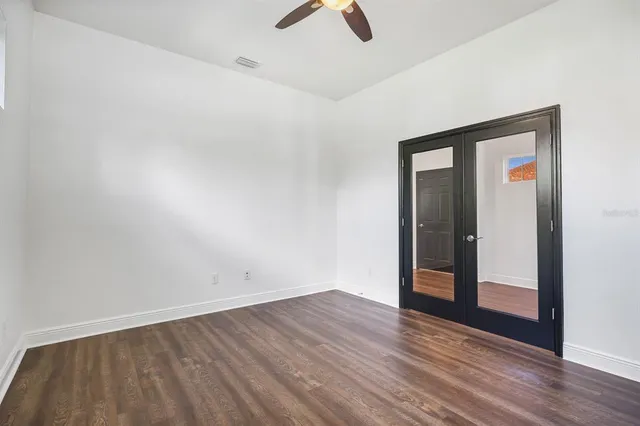 wooden floor in an empty room with a window