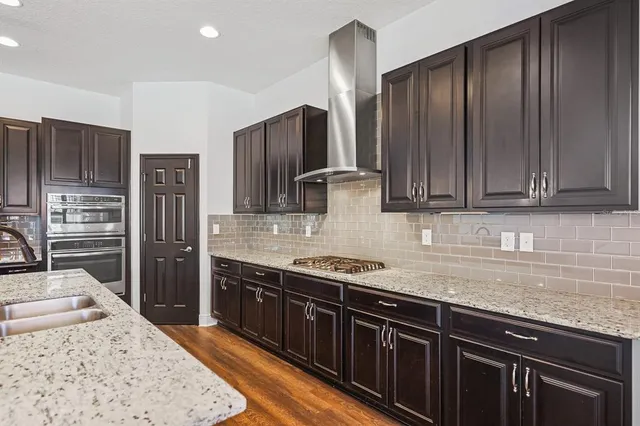 a view of an empty room with wooden floor and closet