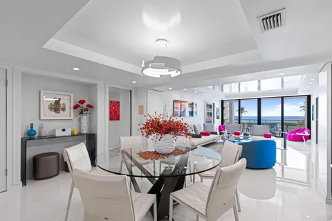 a view of a dining room with furniture and chandelier