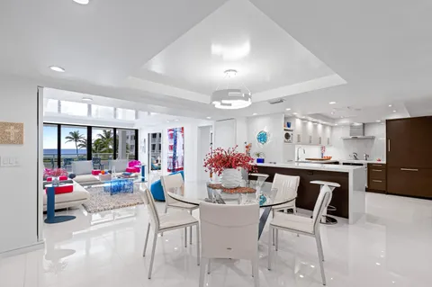 a view of a dining room with furniture and a chandelier