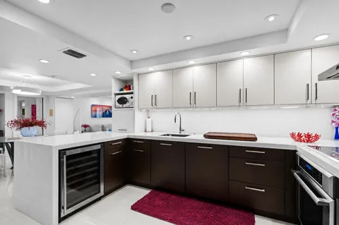 a kitchen with a sink dishwasher and cabinets