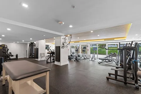 a view of a room with gym equipment and large window