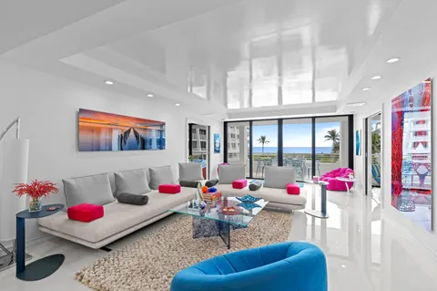 a living room with furniture and flowers