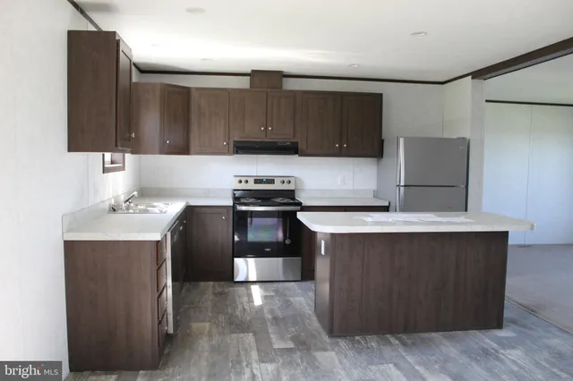 a kitchen with a sink and a refrigerator