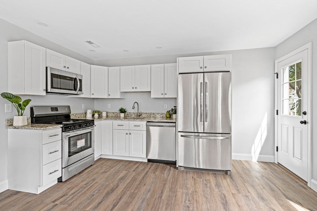 543 Andover Street, Unit 6 Lawrence, MA 01843 - Photo 11 of 27 a kitchen with cabinets stainless steel appliances and wooden floor