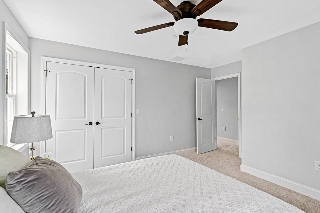 543 Andover Street, Unit 6 Lawrence, MA 01843 - Photo 16 of 27 a bedroom with a bed and a lamp