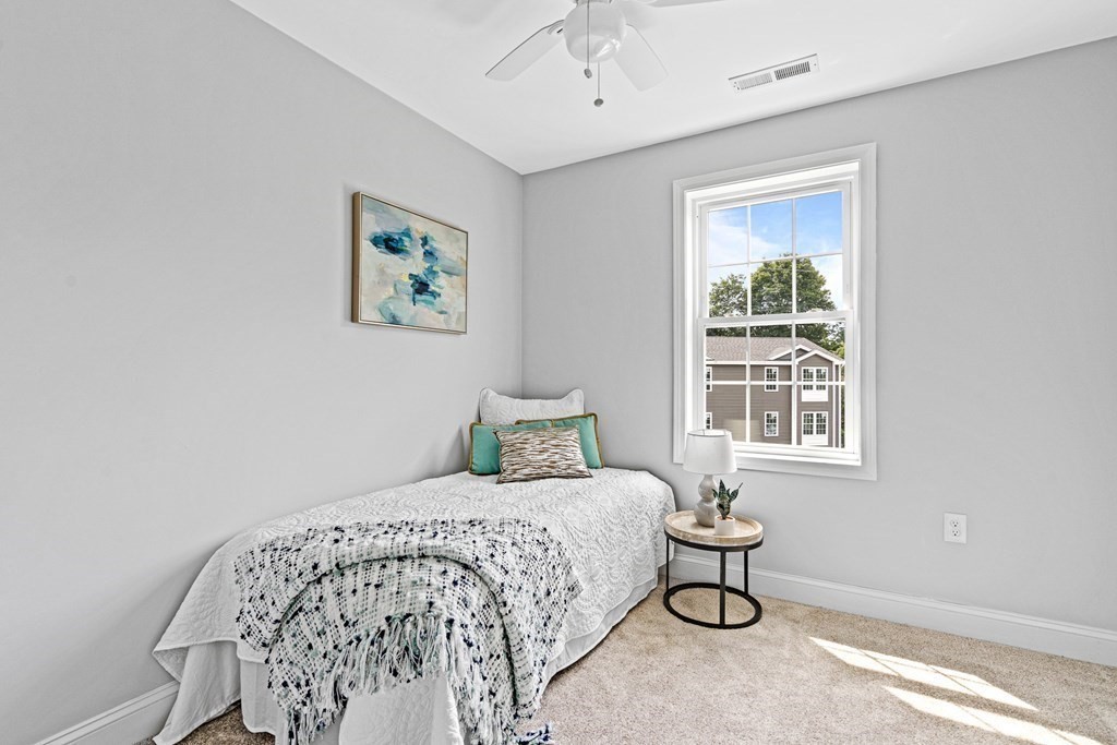 543 Andover Street, Unit 6 Lawrence, MA 01843 - Photo 19 of 27 a bedroom with a bed and a window