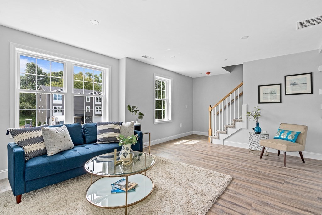 543 Andover Street, Unit 6 Lawrence, MA 01843 - Photo 2 of 27 a living room with furniture and a wooden floor