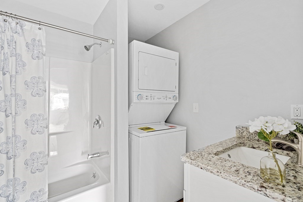 543 Andover Street, Unit 6 Lawrence, MA 01843 - Photo 21 of 27 a bathroom with a granite countertop sink a toilet and shower