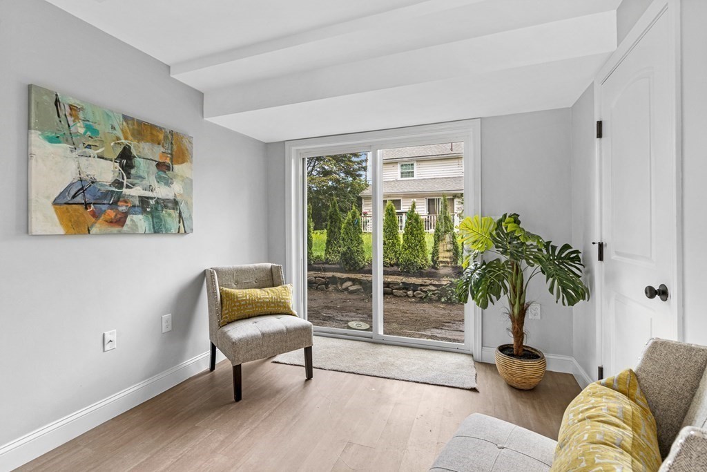 543 Andover Street, Unit 6 Lawrence, MA 01843 - Photo 23 of 27 a living room with furniture and a potted plant