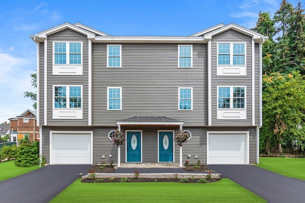 543 Andover Street, Unit 6 Lawrence, MA 01843 - Photo 24 of 27 a front view of a house with a yard and garage