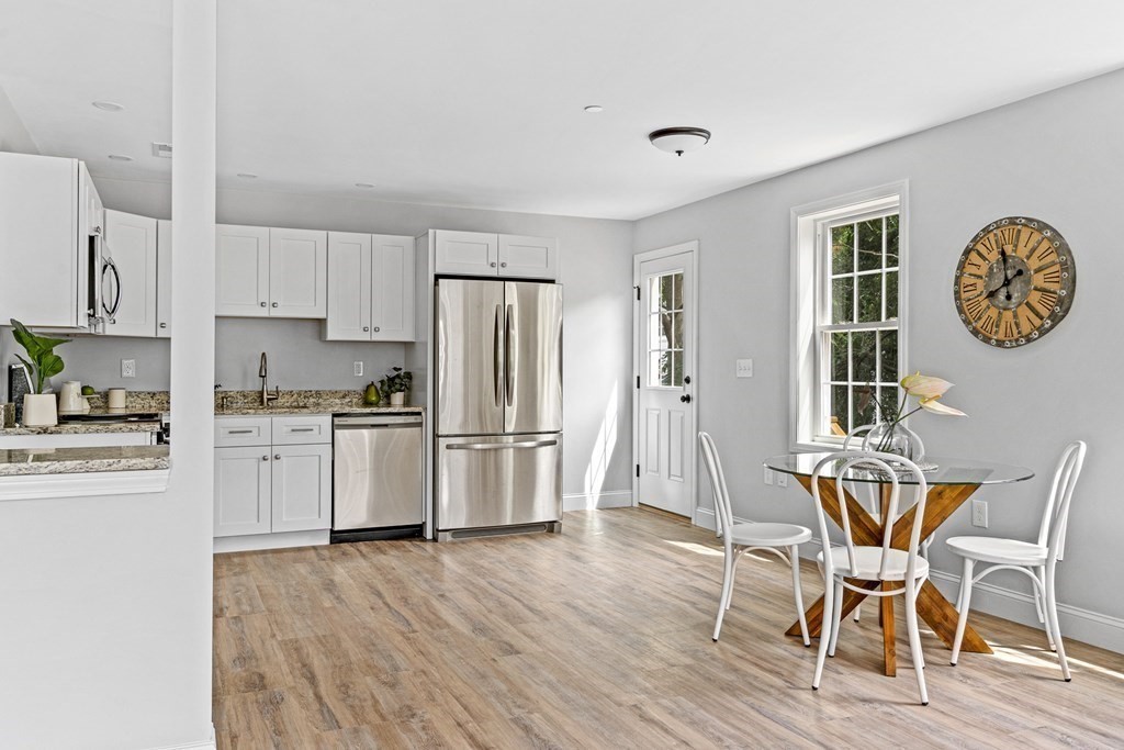 543 Andover Street, Unit 6 Lawrence, MA 01843 - Photo 7 of 27 a kitchen with white cabinets and stainless steel appliances