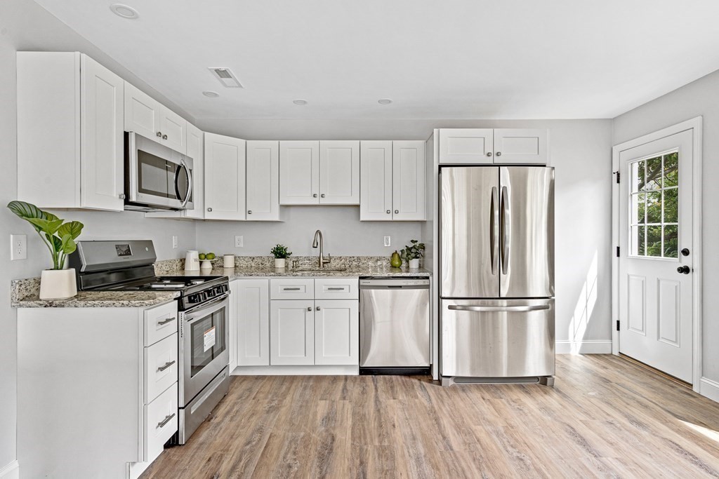 543 Andover Street, Unit 6 Lawrence, MA 01843 - Photo 9 of 27 a kitchen with stainless steel appliances a refrigerator sink and microwave