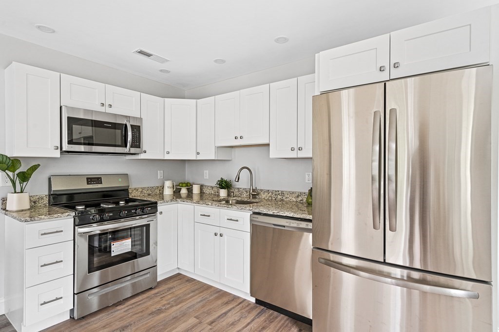 543 Andover Street, Unit 6 Lawrence, MA 01843 - Photo 10 of 27 a kitchen with cabinets stainless steel appliances and wooden floor