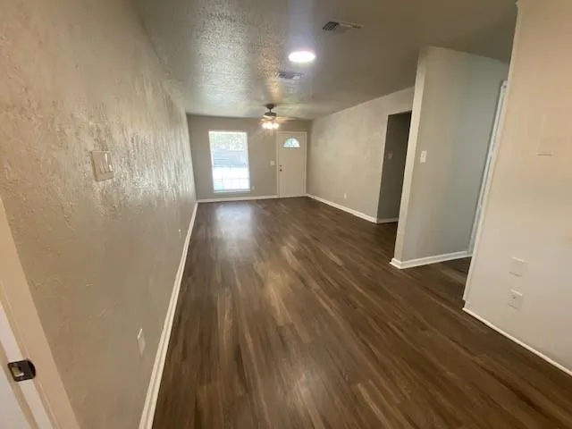 wooden floor in an empty room with a mirror