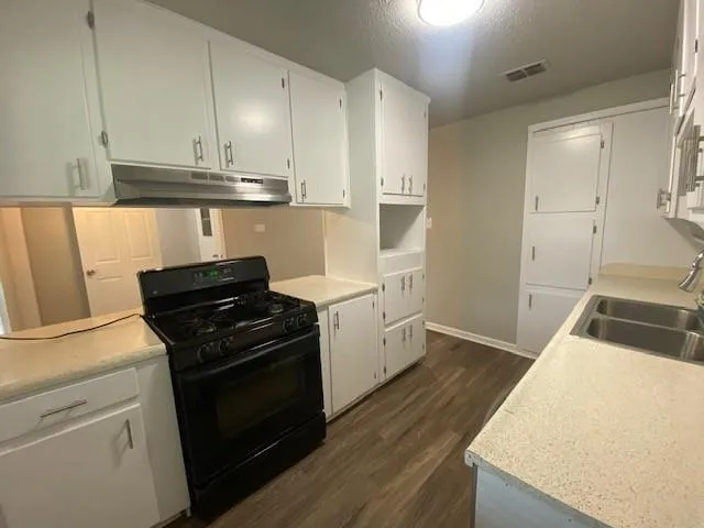 a kitchen with a stove and a refrigerator
