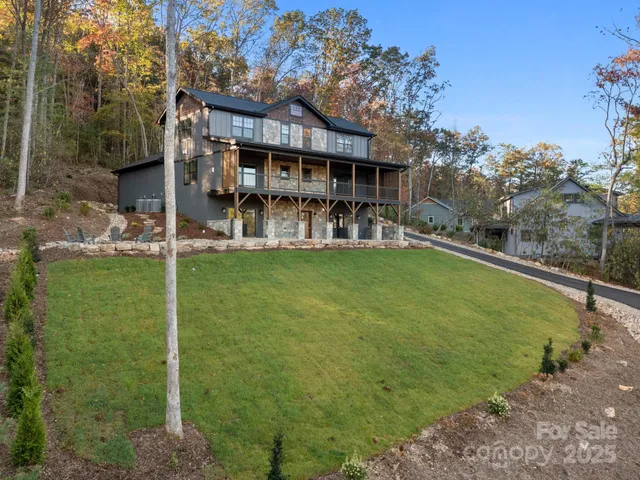a view of a house with a yard patio and swimming pool