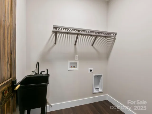 a view of a hallway with wooden floor and a cabinet