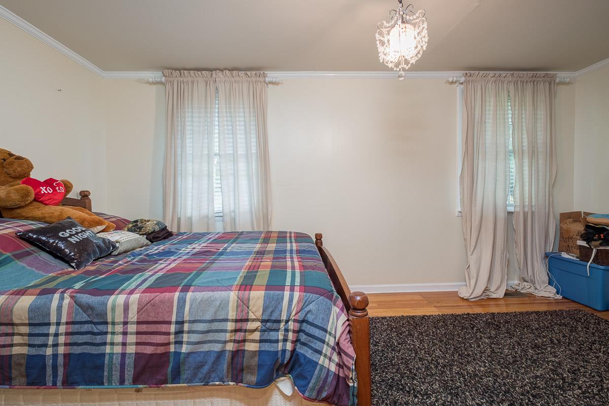 7187 Bahne Road Fairview, TN 37062 - Photo 12 of 30 a bedroom with a bed and a chandelier