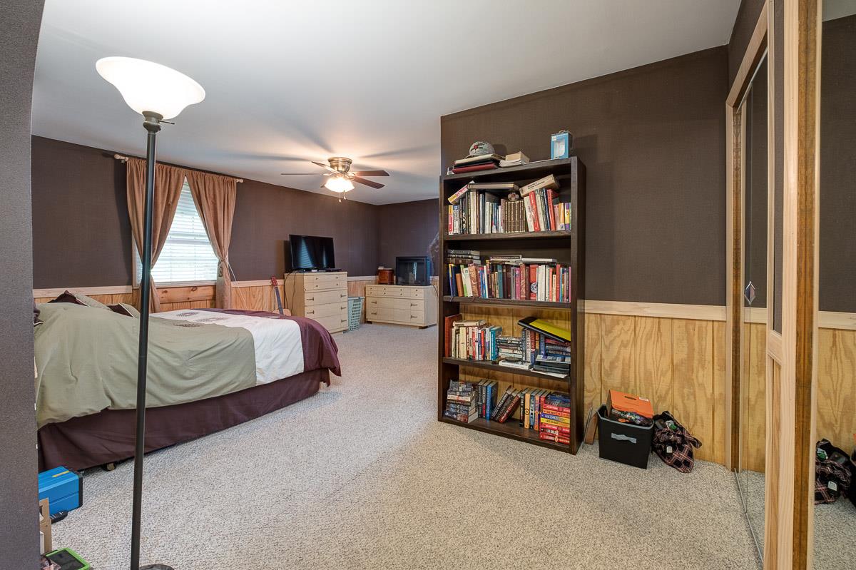 7187 Bahne Road Fairview, TN 37062 - Photo 16 of 30 a bedroom with bed and a book shelf