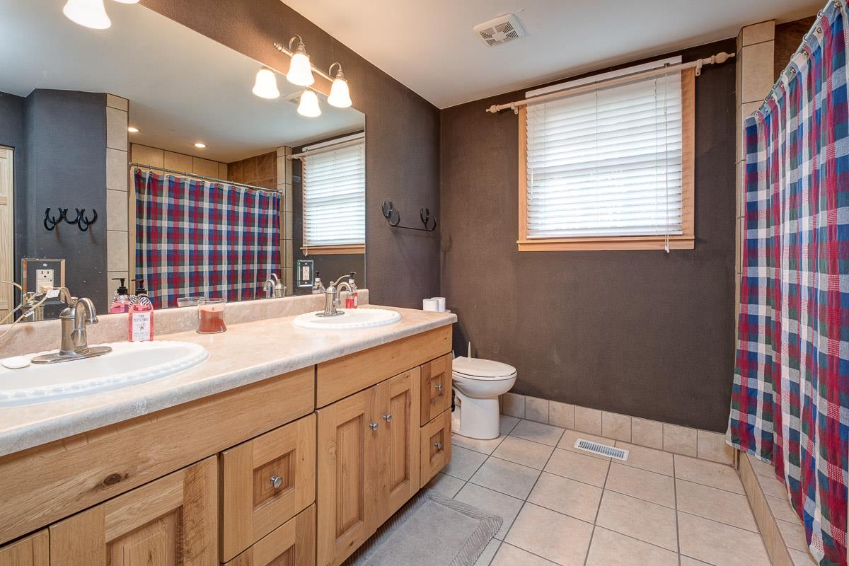 7187 Bahne Road Fairview, TN 37062 - Photo 19 of 30 a bathroom with a sink a vanity and a mirror