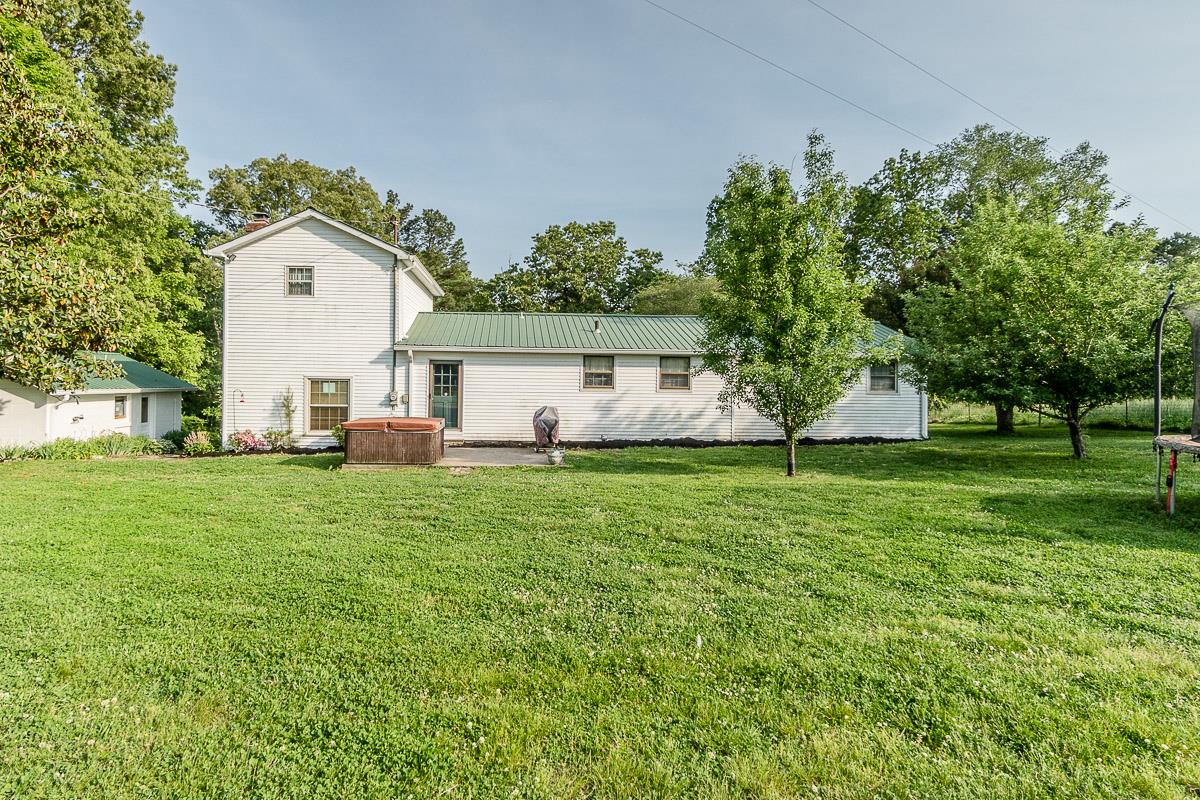 7187 Bahne Road Fairview, TN 37062 - Photo 25 of 30 a view of a white house with a big yard and large trees