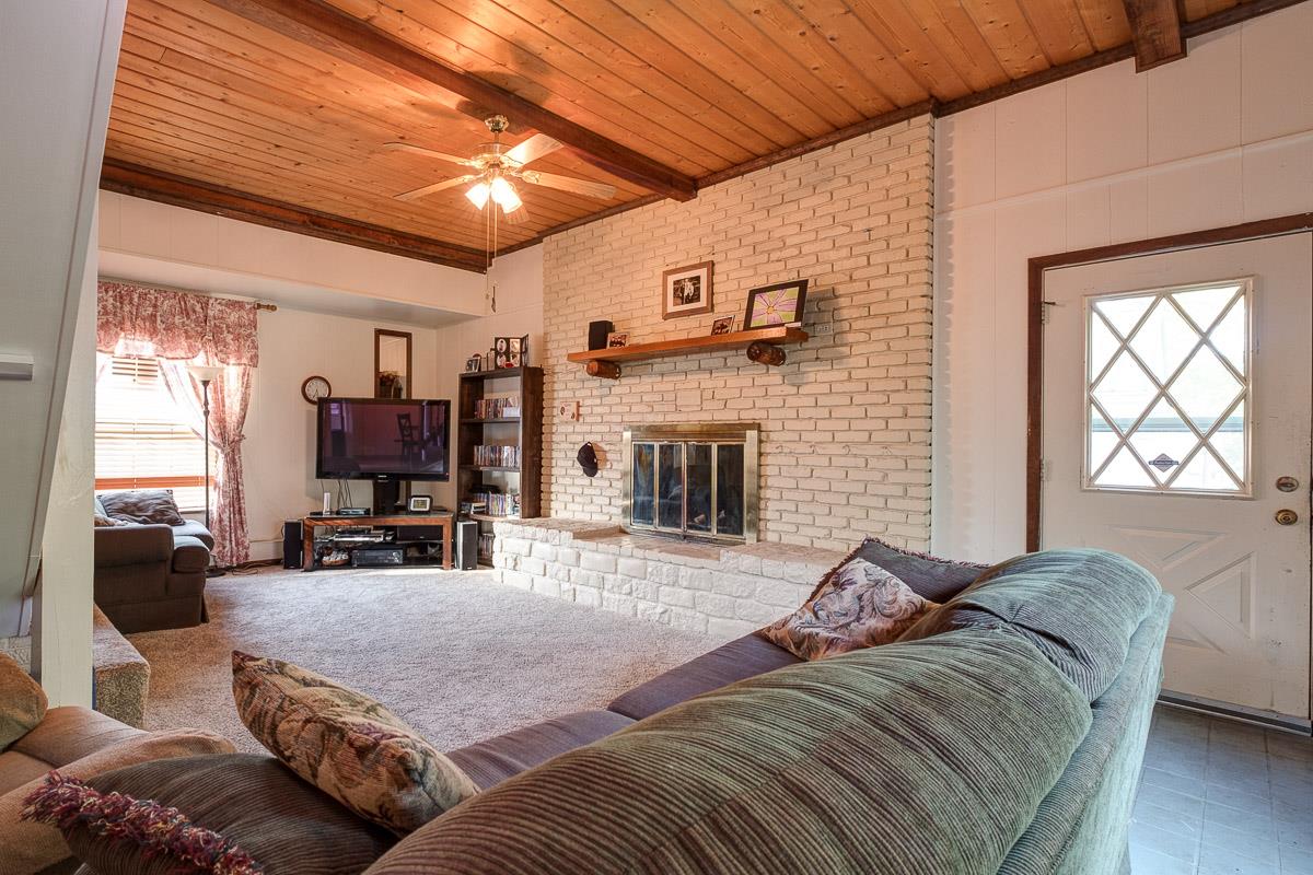 7187 Bahne Road Fairview, TN 37062 - Photo 5 of 30 a living room with furniture a fireplace and a flat screen tv
