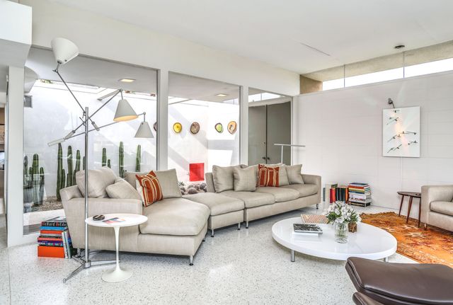 a living room with furniture and a large window