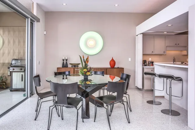 a view of a dining room with furniture and a mirror